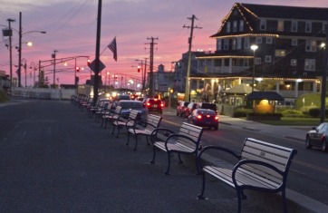 Evening image of the road in front of Stockton Inns with cars driving and the sunset in the background